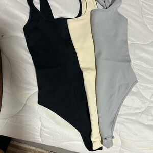 Black, Cream, and Gray Ribbed Bodysuits